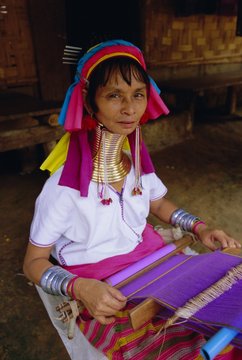 Portrait of a 'Long necked' Padaung tribe woman weaving on a hand held loom, Mae Hong Son Province, northern Thailand