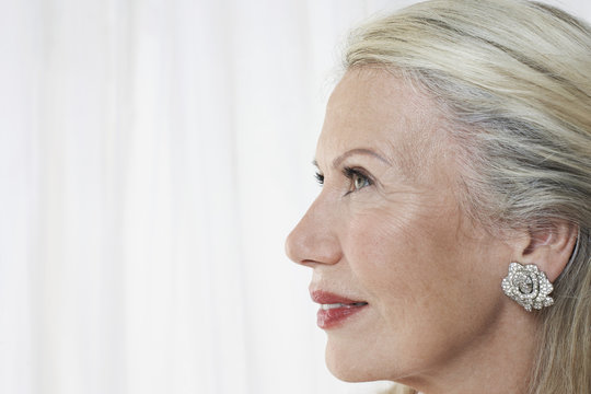 Closeup Profile Of A Beautiful Senior Woman Against White Background