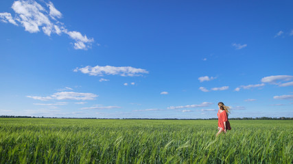 Charming blonde woman at a green field