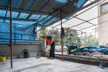 Waterproofing and isolation works of a terrace - roof:  roofer is cleaning the bottom of a terrace...