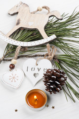 Golden lit candle, wooden christmas toys