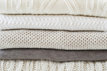 Stack of warm knitted sweaters