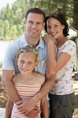 Portrait of happy parents with daughter outdoors