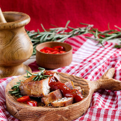 Grilled meat with rosemary and sauce on the kitchen Board