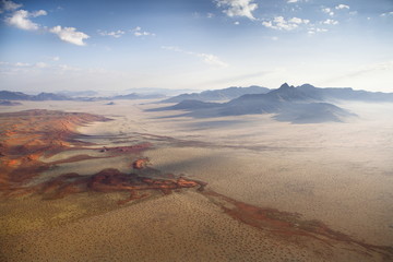 Aerial view from hot air balloon over magnificent desert landscape of sand dunes, mountains and Fairy Circles, Namib Rand game reserve Namib Naukluft Park, Namibia