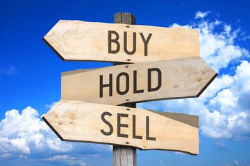 Buy, hold, sell - wooden signpost