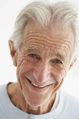 Closeup portrait of happy old man isolated over white background