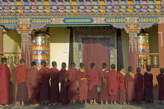 Novice monks line up in front of monastic building at the new Karma Theckhling Monastery, built in traditional Sikkim style, Ravangla (Rabongla), Sikkim