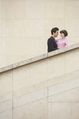 Low angle view of a young couple embracing on stairway