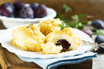Cottage cheese and potato dough dumplings with plums