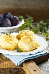 Cottage cheese and potato dough dumplings with plums