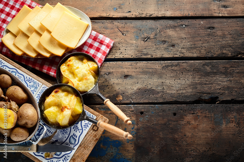 Wall mural Delicious traditional Swiss melted raclette cheese