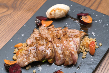 pork steak with vegetable on a granite plate

