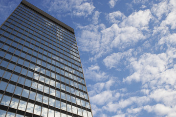 Fototapeta na wymiar Sky and clouds reflecting in skyscraper windows low angle view