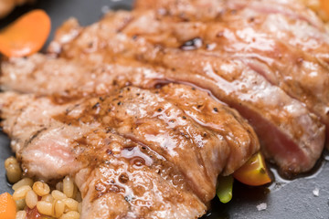 pork steak with vegetable on a granite plate

