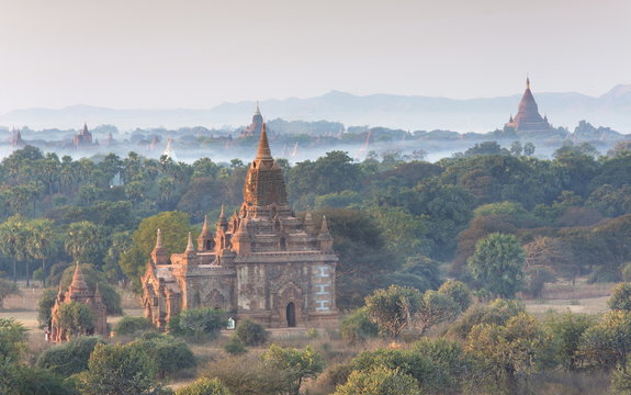 View over the temples of Bagan swathed in early morning mist, from Shwesandaw Paya, Bagan