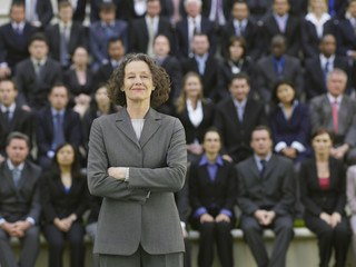 Portrait of a businesswoman in front of blurred multiethnic businesspeople