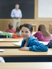 Portrait of a female in lecture room with blurred students