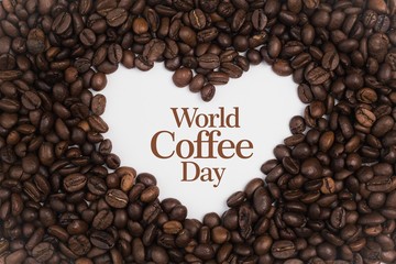 Background made of coffee beans in a heart shape with message 
