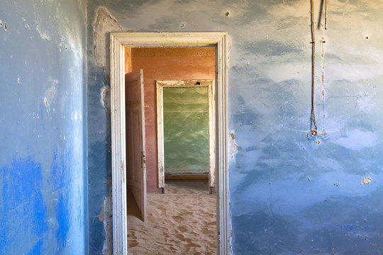 Interior of building slowly being consumed by the sands of the Namib Desert in the abandoned former German diamond mining town of Kolmanskop, Forbidden Diamond Area near Luderitz, Namibia 