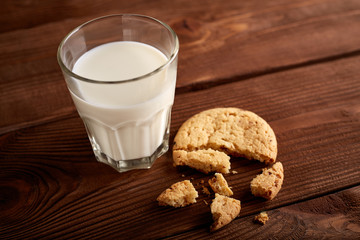 Cookies and milk. Chocolate chip cookies and a glass of milk. Vintage look. Tasty cookies and glass of milk on rustic wooden background. Food, junk-food, culinary, baking and eating concept
