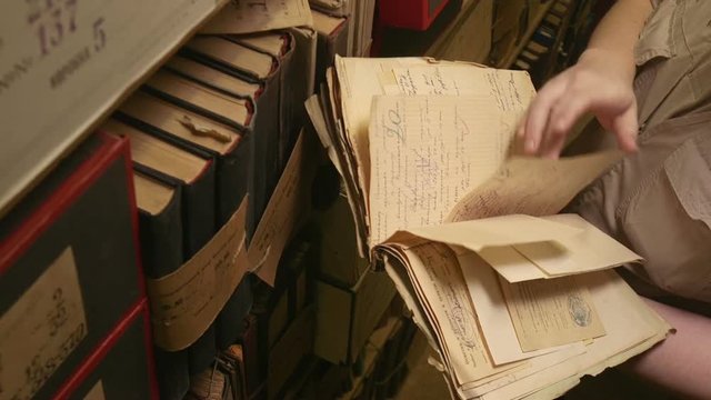 Man looking documents in the archive.