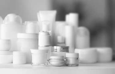 Set of cosmetics on white table against blurred background, close up view