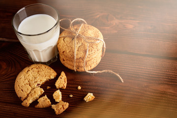 Cookies and milk. Chocolate chip cookies and a glass of milk. Vintage look. Tasty cookies and glass of milk on rustic wooden background. Food, junk-food, culinary, baking and eating concept