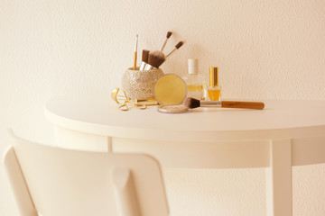 Set of cosmetics on white table against light textured background