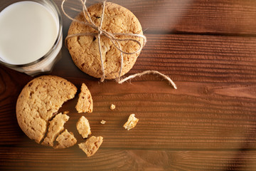 Cookies and milk. Chocolate chip cookies and a glass of milk. Vintage look. Tasty cookies and glass of milk on rustic wooden background. Food, junk-food, culinary, baking and eating concept