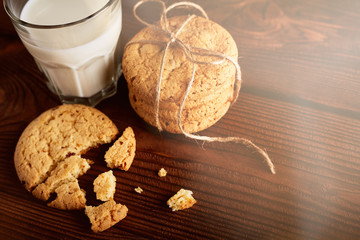 Cookies and milk. Chocolate chip cookies and a glass of milk. Vintage look. Tasty cookies and glass of milk on rustic wooden background. Food, junk-food, culinary, baking and eating concept