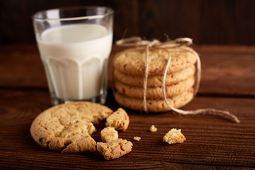 Cookies and milk. Chocolate chip cookies and a glass of milk. Vintage look. Tasty cookies and glass of milk on rustic wooden background. Food, junk-food, culinary, baking and eating concept