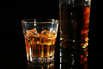 Glass of whisky on dark background