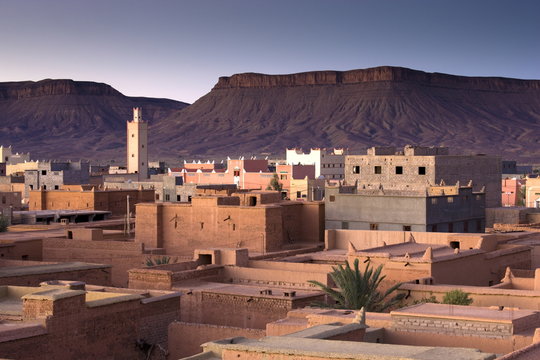 View over town of Nkob bathed in morning sunlight with modern minaret in the distance, Nkon, southern Morocco, Morocco