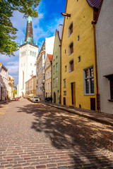 Street view with colorful buildings and church tower in the old town of Tallinn, Estonia