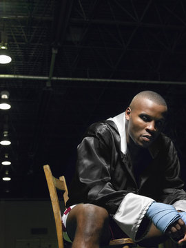 Portrait of an African American boxer sitting on chair