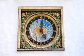 Fototapeta na wymiar Ancient clock on the church of Holy Spirit in the old town of Tallinn, Estonia