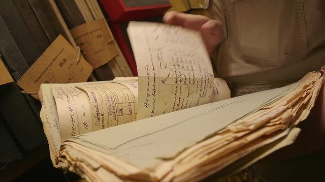 Man looking documents in the archive.
