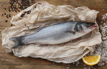 Raw fish with spices on paper