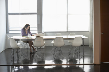 Young businesswoman sitting in conference room