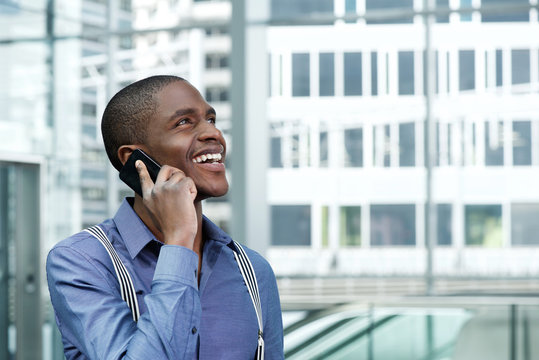 smiling african american businessman using cellphone