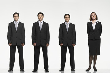 Full length portrait of businesspeople standing side by side against white background