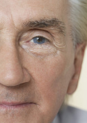 Detail portrait shot of a senior man's face with blue eye