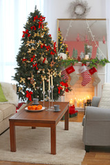 Interior of beautiful living room with fireplace decorated for Christmas