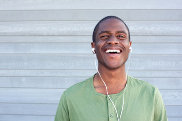 young black guy smiling with earphones