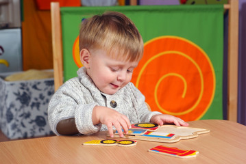 Little boy playing and learning in preschool