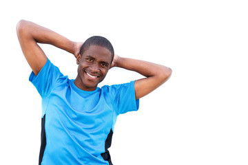 young man smiling with hands behind head on isolated white background