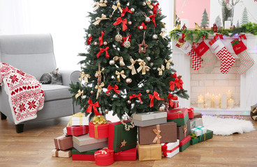 Beautiful Christmas tree with presents in living room