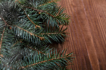 Christmas background with xmas tree and sparkle bokeh lights on wooden canvas background. Merry christmas card. Winter holiday theme. Happy New Year. Space for text. Happy Holidays