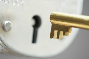 Golden key and padlock close-up selective focus